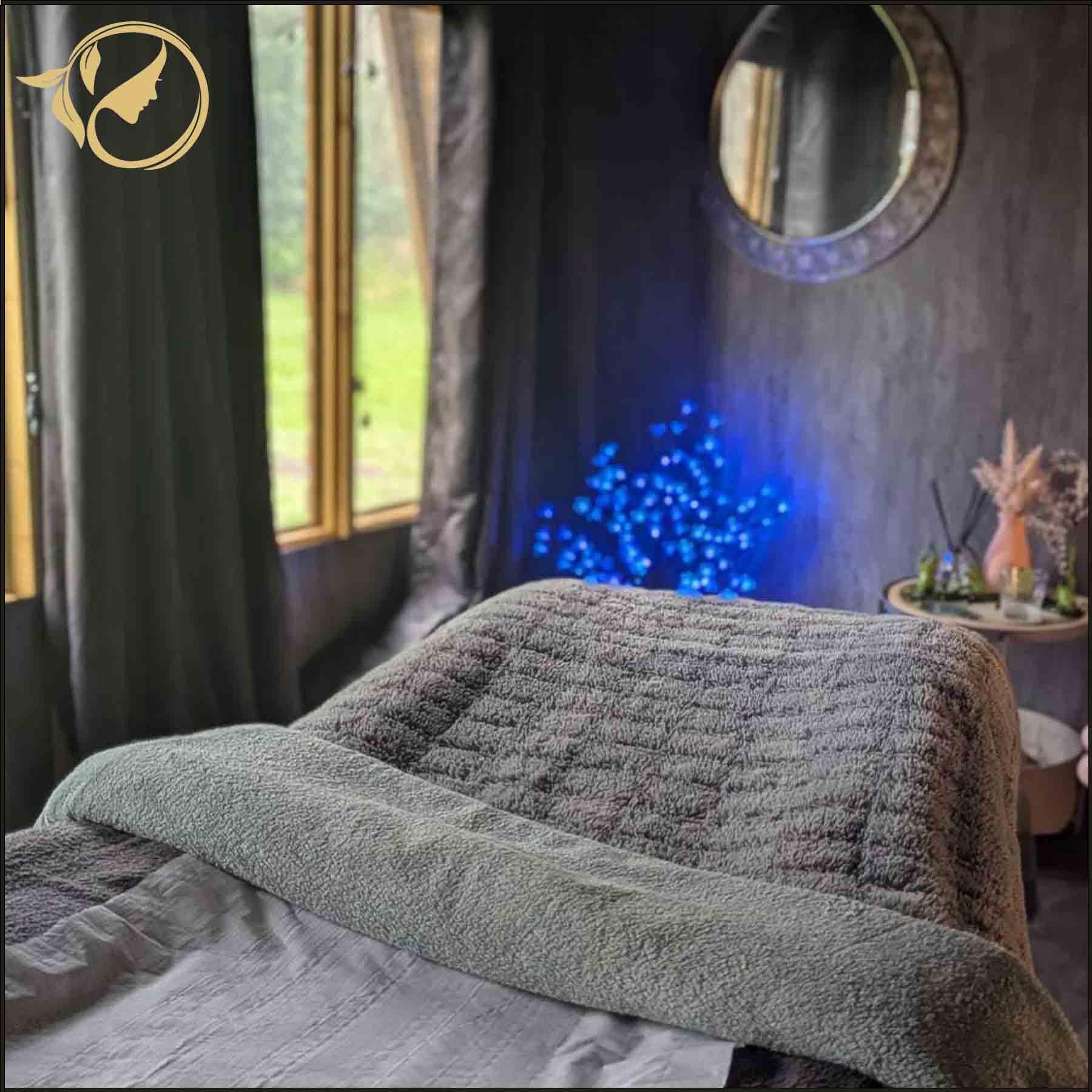 Luxury heated treatment couch inside the private single client beauty room at The Tollwood Retreat.
